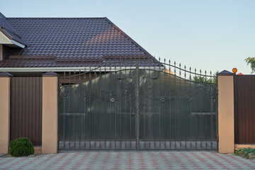 Forged metal gates with ornate lines to enter a private house