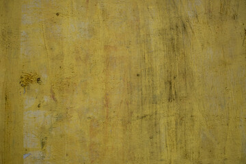 old concrete yellow wall with white paint spots and black scratches. rough surface texture