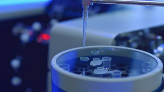 Apparatus for automatic sampling, analysis. A robo hand takes a sample from a test tube for testing or analysis. New technologies in science. Artificial intelligence is conducting an experiment.