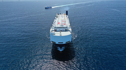 Aerial drone photo of huge car carrier ship RO-RO (Roll on Roll off) cruising in Mediterranean deep blue Aegean sea