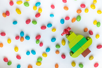 fur-tree from the constructor and multicolored spots on a white background