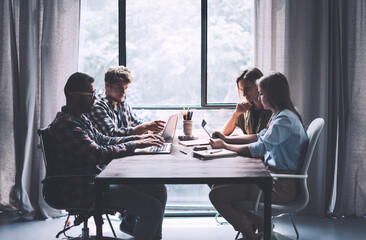 Group of young people working or studying together. Hipster team in coworking. Young modern business colleagues. Startup concept