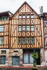 Typical Old Half-timbered houses at Rue Eau de Robec in Rouen on a rainy day. Rue Eau-de-Robec is one of the main tourist streets of Rouen. Upper Normandy, France.
