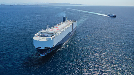 Aerial drone photo of huge car carrier ship RO-RO (Roll on Roll off) cruising in Mediterranean deep blue Aegean sea
