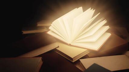 Mysterious open book with magic bright light between a bunch of other old books on a dark background. Concept of education, the great value of books.