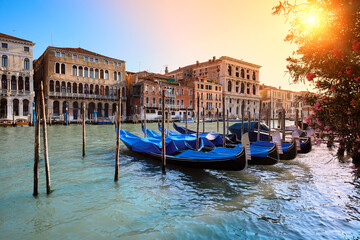 Several gondolas moored by the pier on Grand Canal in Venice, Italy.