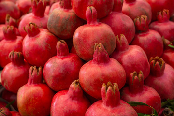 Photo of ripe red pomegranates on the market.