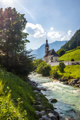 sunny day by the river next to the church in Ramsau, Germany