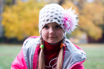 girl in red clothes makes faces and smiles