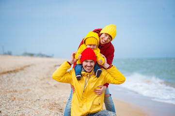 Happy Family on the seashore in colorful clothes.
