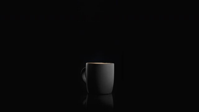 4k shot of a coffee drop falling in slow motion into a fresh and aromatic coffee in a modern matte black cup