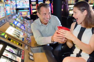 friends playing with slot machines