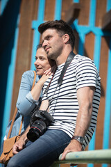 young beautiful couple in love sitting on old city street