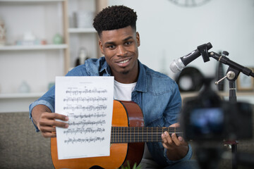 guitarist recording a video of himself