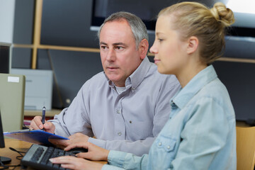 teacher assessing a student using a computer