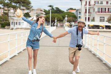 Fototapeta premium beautiful couple walking on the beach having fun