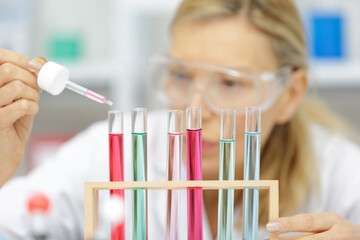 senior woman scientist in protective gloves