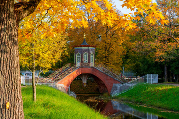 Cross bridge in autumn foliage in Alexander park, Tsarskoe Selo (Pushkin), Saint Petersburg, Russia