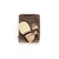 Brown set of bath accessories isolated on white background. Spa zero waste concept. Natural washcloth, Wooden heart, burlap sack with herbals and aroma oil for aromatherapy. Eco lifestyle flat lay