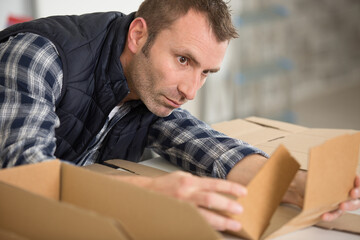 male worker costructing a cardboard box