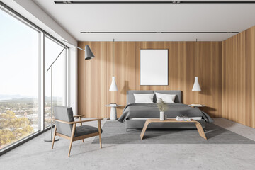 White and wooden bedroom interior with armchair and poster