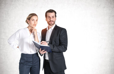 Thinking young businessman and businesswoman
