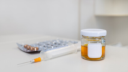 Abstract medical still life on white background of hospital clinic. Yellow liquid in glass vial,...