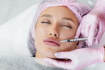 Cosmetology procedure for lip augmentation and wrinkle removal for a young beautiful girl. Cosmetology