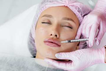 Cosmetology procedure for lip augmentation and wrinkle removal for a young beautiful girl....