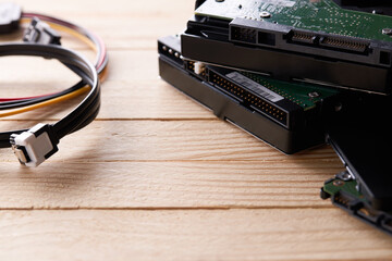 data storage hardware for desktop and laptop computers. backup data technology concept. stack of hard drive disc over wooden background. information recovery conceptual