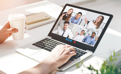 Man drinking coffee during his video chat