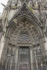 Fototapeta na wymiar Saints Statues at central portal of western facade of Saint-Ouen-de-Rouen. Rouen Saint-Ouen Abbey Church (Abbatiale Saint-Ouen, 1318 - 1537) - Gothic Roman Catholic church in Rouen, Normandy, France.
