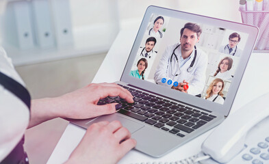 Fototapeta na wymiar Young woman video chatting with medical doctors