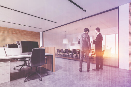 Two Businessmen Talking In White And Wooden Open Space Office Co