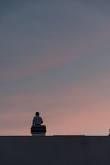 silhouette of a person at sunset in a roof