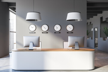 Reception desk with clocks in modern gray office lobby