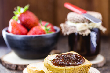 toast with strawberry jam, with jar of strawberry jam in the background, healthy breakfast