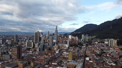 Obraz premium Aerial View of the Urban Landscape Full of High Buildings Surrounded of Mountains in Bogota, Colombia