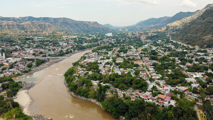 Hanging Bridge that Passes over a River Surrounded by a Lot of Vegetation in Honda, Tolima /...