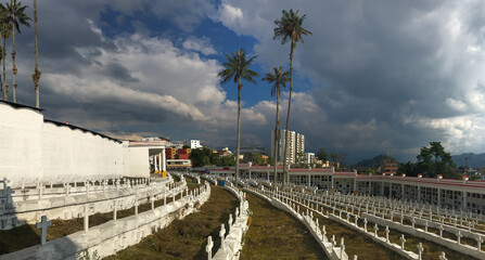 Fototapeta premium The White Tombs with Crosses, with Flowers in the Old Spanish Colonial Historic Cemetery