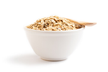 Oat flakes on a bowl and a wooden spoon