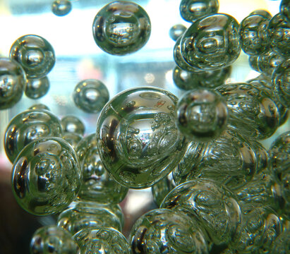 Macro images of bubbles in light green liquid