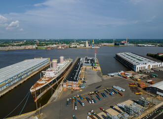 Shipyard industry aerial view of large ship big tanker under repairing in floating dock on the river Delaware Pennsylvania