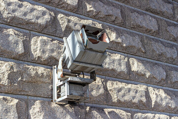 Old searchlight on the stone wall, for night lighting of the bridge