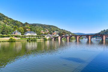 Fototapeta na wymiar View of bridge called 'Karl Theodor Bridge', also known as the Old Bridge, an arch bridge in city Heidelberg in Germany that crosses the Neckar river with Odenwald forest in background