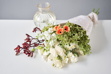 Bouquet 003. Sekective focus on flowers. Series, step by step installation of flowers in a vase. Flowers bunch, set for home. Delivery fresh cut flower.