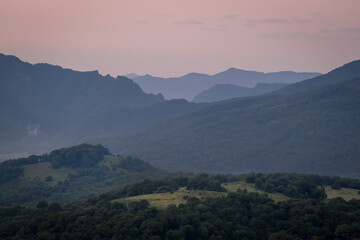 Early morning one hour before dawn. Silhouettes of mountains in the morning haze. Lagonaki Plateau, Republic of Adygea, Russia