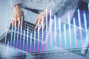 Multi exposure of woman hands working on computer and forex chart hologram drawing. Top View. Financial analysis concept.