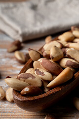 Heap of cream brazil nuts close up, mellow colors, rustic style