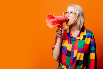Style blonde in 90s clothes and rainbow glasses with megaphone